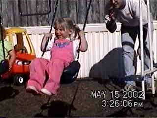 Shawn pushing Carrie on the swing - 5/15/02