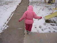 Carrie going outside to play in the snow while waiting for her bus