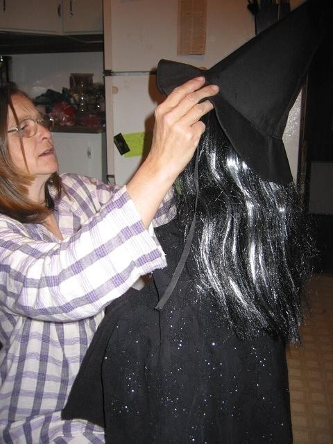 Now Grandmom helps Carrie put her hat on.