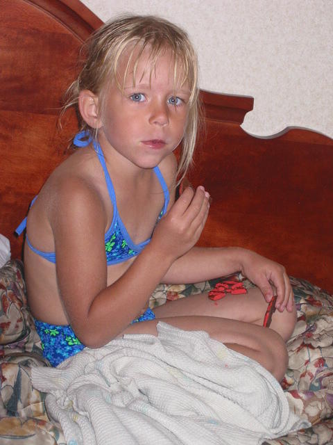 Carrie, in her bikini, eating cookies.