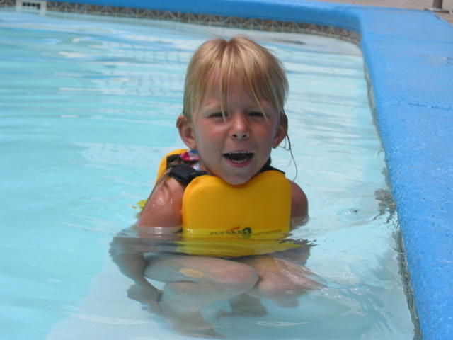 Carrie standing on the seat in the pool.