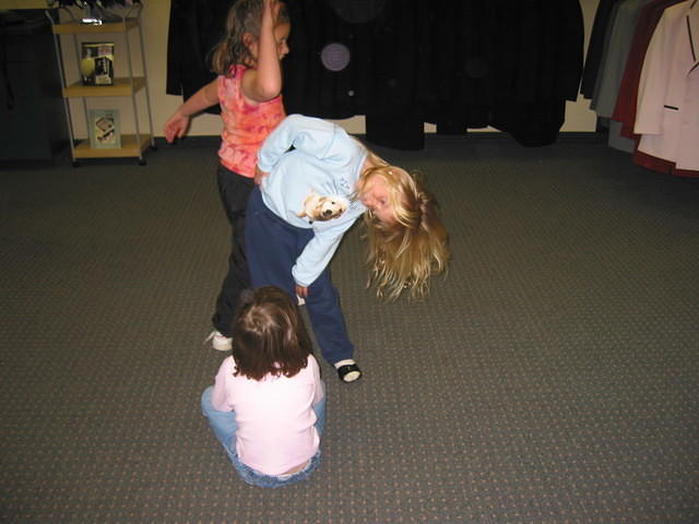 Carrie playing with two girls at the tux shop.