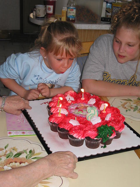 Carrie still trying to blow out the candles.