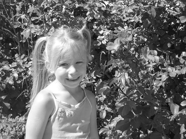 Carrie and I walking to the park, stopped to see the flowers.