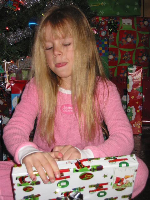 Tongue out while opening another present