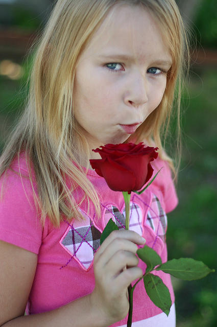 Carrie, still singing into her rose