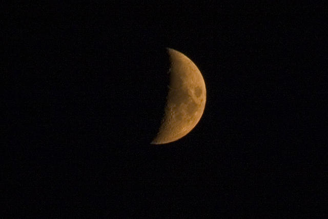 The moon is orangeish becuase of the fires.