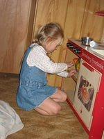 Carrie reaches into the oven