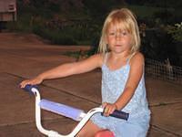 Carrie riding a bike at Gram and Pap's