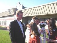 The wedding party steps outside for the reception line, and greets all of the guests.
