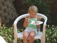 Carrie eating Dad's birthday cake.