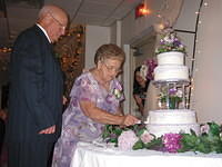 Gram and Pap cutting the cake.