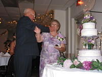 Pap smearing cake on Gram while feeding it to her.