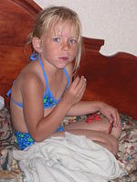 Carrie, in her bikini, eating cookies.