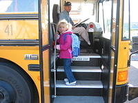 Carrie climbing on the bus.