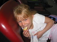 Carrie eating a cinnamon roll in Cincinnati airport.