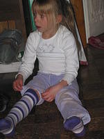 Carrie putting back on her knee socks.