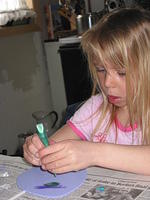 Carrie decorating Easter eggs for the front door. :D