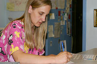 The lady at the humane society writing out a receipt for Carrie's donation
