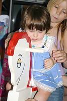 Carrie helping Joleigh on her rocking horse.