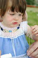 Joleigh, fascinated by the dandelion